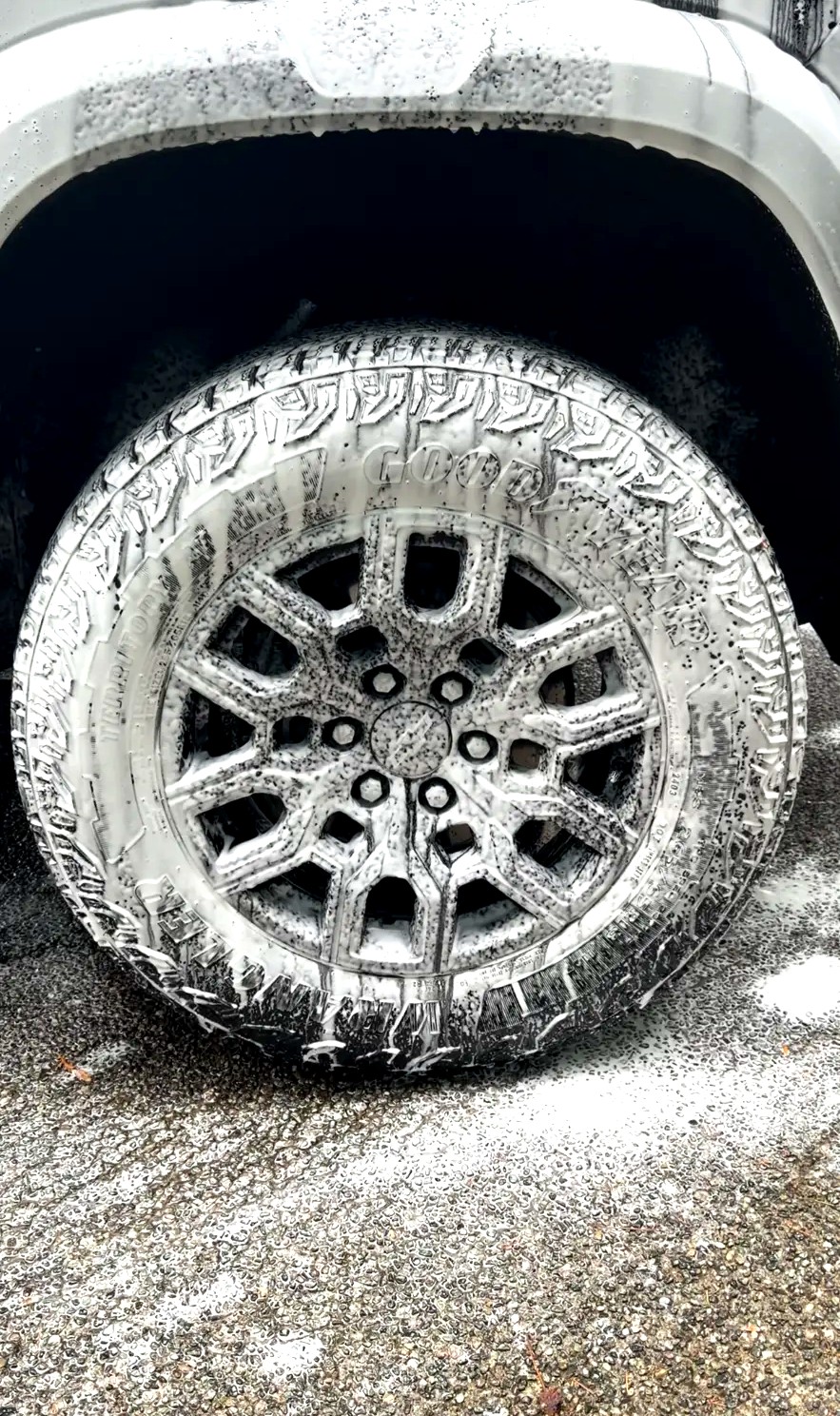 Chevy Colorado wheel and tire covered in cleaning foam during the wash